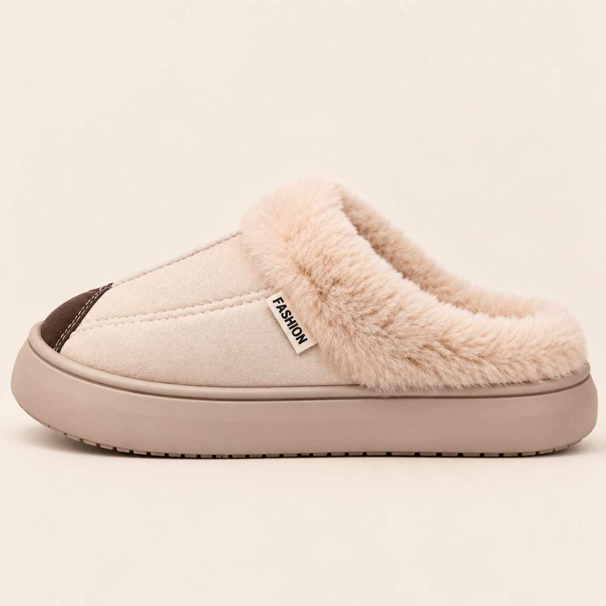 A single slip-on mule slipper shown in profile against a solid light beige background. The slipper features a cream canvas upper, a thick beige sole, a soft beige faux-fur collar, and a dark brown accent on the toe cap.