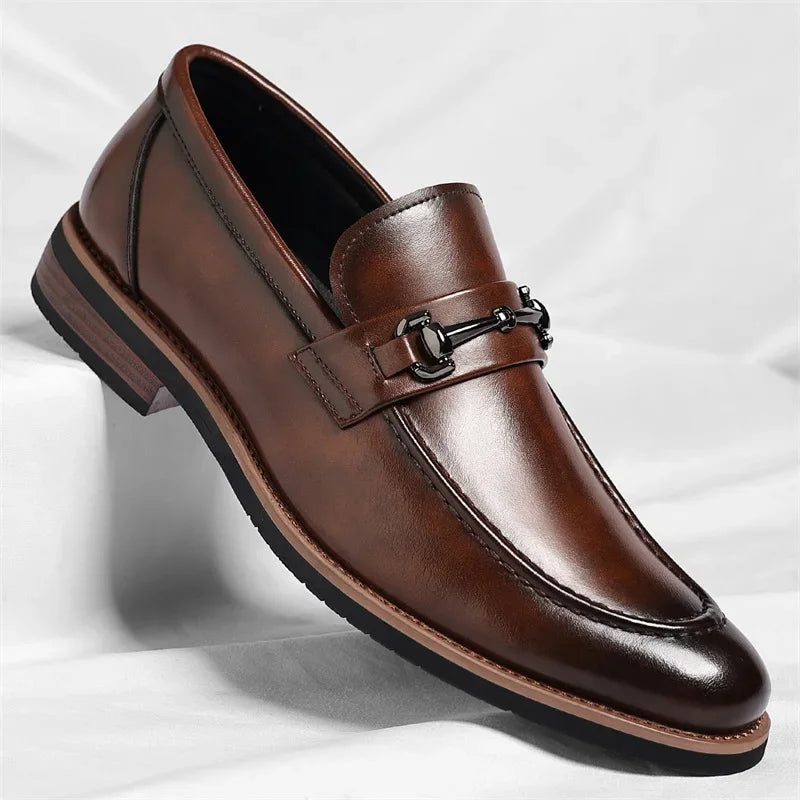 Brown leather loafer shoe on a light gray background